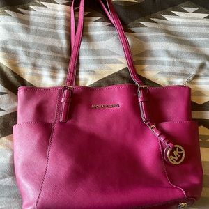 COPY - Michael Kors Hot pink purse with crossbody strap.